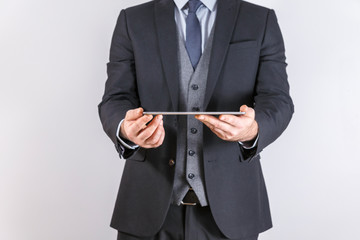 Businessman in suit hold Tablet isolated on white background