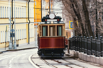 Fototapeta na wymiar Vintage tram on the town street in the historical city center.