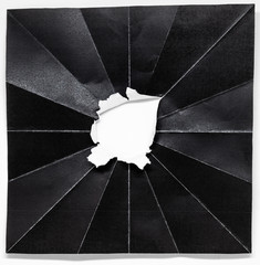 Hole in the center of Folded black paper with diagonal style on white background