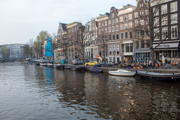 Walk the streets of Amsterdam. Canals, tulips, bicycles, boats.