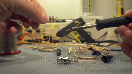 Electronics engineer testing and repairing electronic cables in his workshop - accelerated video