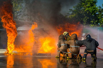 Firemen are using water to extinguish the fire. Firefighter training.