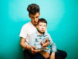 young pretty man model with little cute son playing together, lifestyle modern people concept, family male close up