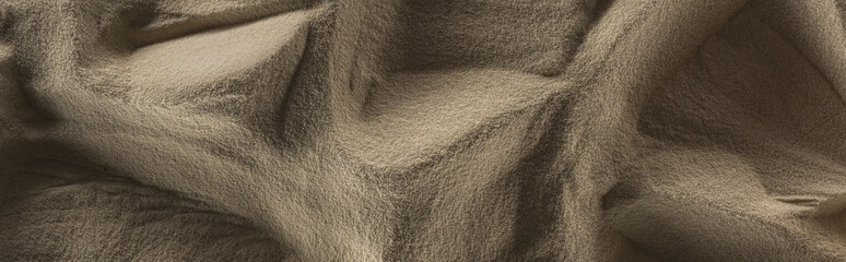 panoramic shot of textured golden sand with shadows