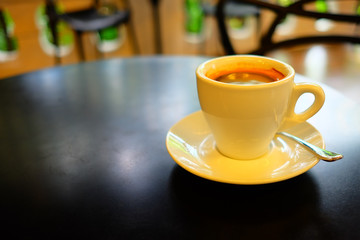 Close up Hot Americano Coffee in White Cup on Black Table.