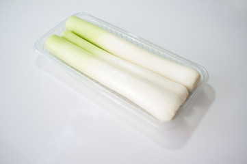 Leeks on plastic tray package