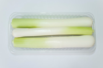 Leeks on plastic tray package