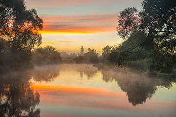 Fog over the river at sunrise time