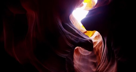 Traveling low angle shot of beautiful red rock cave eroded in 4K
