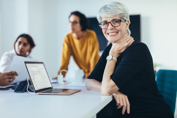 Successful mid adult woman at meeting
