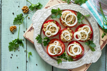 Georgian cuisine. Fresh homemade tomatoes and walnut coriander sauce on the kitchen wooden table. Top view flat lay background.