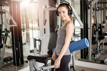 Fototapeta premium Pretty young sport woman is workout with mat in gym, Healthy lifestyle