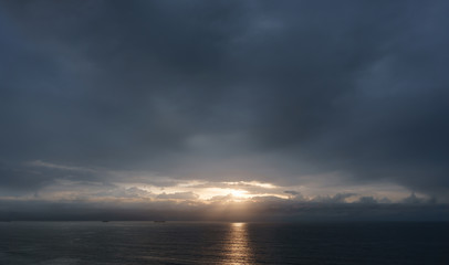 Naklejka na ściany i meble dark cloudscape sunset over the sea