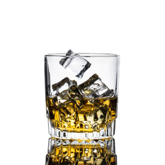 Whiskey Glass closeup, white background, with many ice cubes falling and splashing