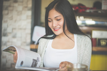 Portrait of woman reading a book at coffee cafe