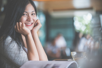 Portrait of woman reading a book at coffee cafe