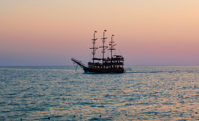 Fototapeta na wymiar vintage boat in the sea. sunset