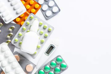 Tablets and medicines on a white top view.