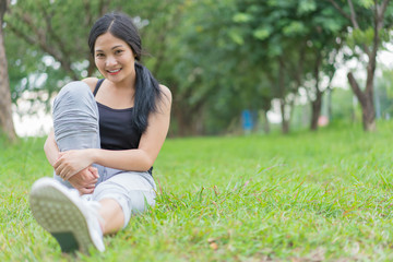 Young female warm up before exercise at the park