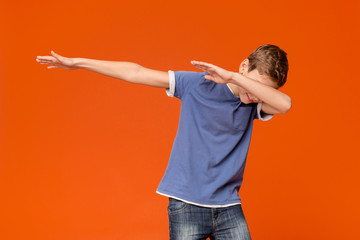 Trendy teenager making dab gesture, having fun