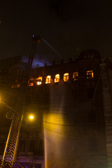 fire in the windows of the old building at night in winter against the background of garlands. fire extinguishing. Kiev, January 20, 2018
