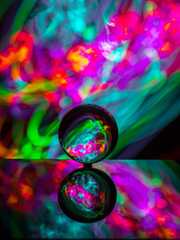 crystal ball on reflective surface with colorful lights background