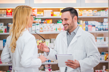 Fototapeta na wymiar Two healthcare workers talking at drugstore.