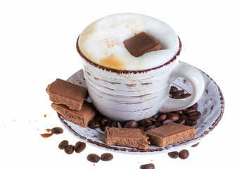 Cappuccino coffee on a white background with milk chocolate and coffee beans.