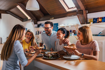 Enjoying pizza with friends at home.