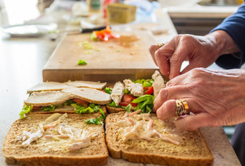 Woman making sandwiches in the kitchen