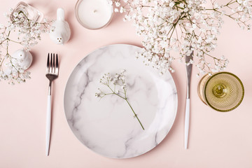 Romantic table setting in pink colors. White flowers decor