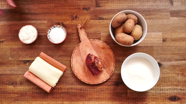 Ingredients to make potato dumplings with sheep cheese and bacon