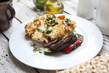 A healthy vegetable diet. Cauliflower with mushrooms baked potatoes. Vegetarian cooking