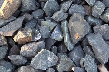 mound of small and large crushed stones with golden light rays