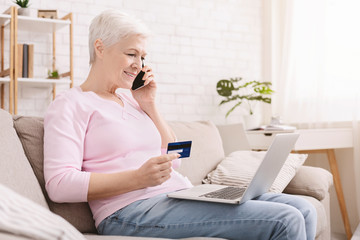 Senior woman shopping online and talking on phone