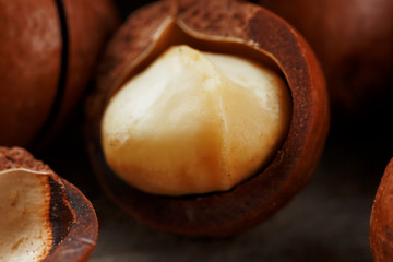Macadamia nut on a wooden table in a bag, closeup, top view