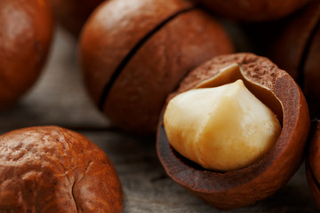 Macadamia nut on a wooden table in a bag, closeup, top view