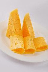 Cheese slice isolated on gray background cutout on a plate