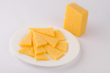 Cheese slice isolated on gray background cutout on a plate