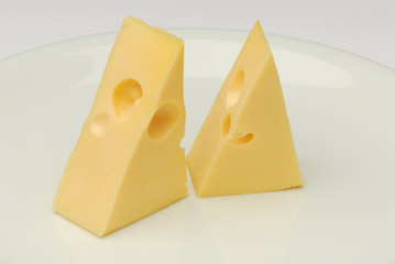 Cheese slice isolated on gray background cutout on a plate