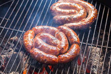 BBQ with fiery sausages on the grill
