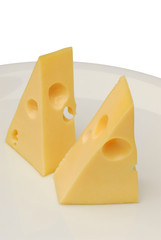 Cheese slice isolated on white background cutout on a plate