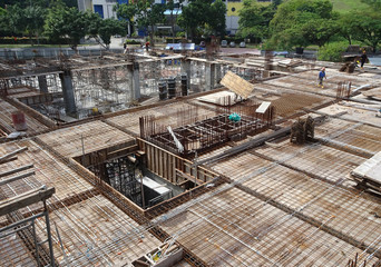 Fototapeta premium Floor slab and beam reinforcement bar under fabrication at the construction site by workers. It is tied it together using tiny wires. 