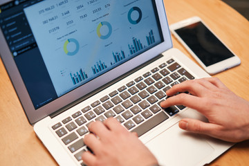 Closeup of man working on laptop with finances or ceo, graph, business analytics and strategy