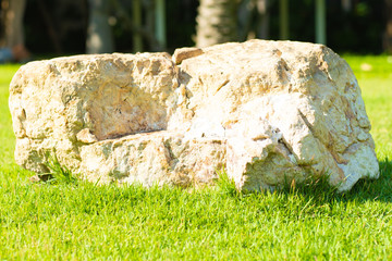 background image Large stone on green grass, copy space.