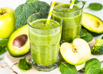 Green smoothie from fruit and vegetable on white.