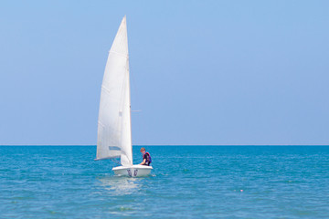Obraz premium Man sailing. Boy learning to sail on sea yacht.