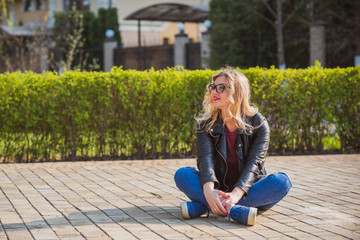 Fashionable woman in glasses wear leather jacket and jeans, casual trend 