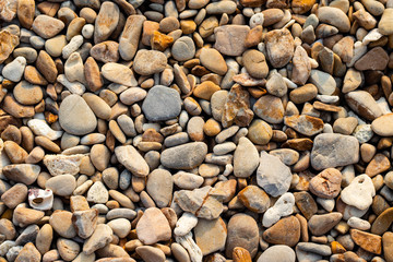 Stone gravel, beach area stone gravel several colors and coral fragments at have shape rounded round caused because of sea waves make give objects bump together all the time cause beauty naturally.