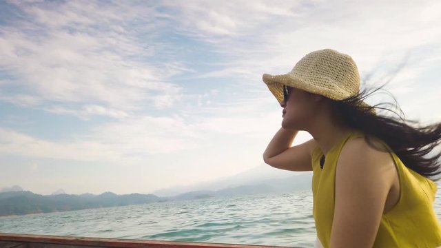 Happy Asian Woman Wear Hat And Sun Glasses Travel By Boat On The Ocean 